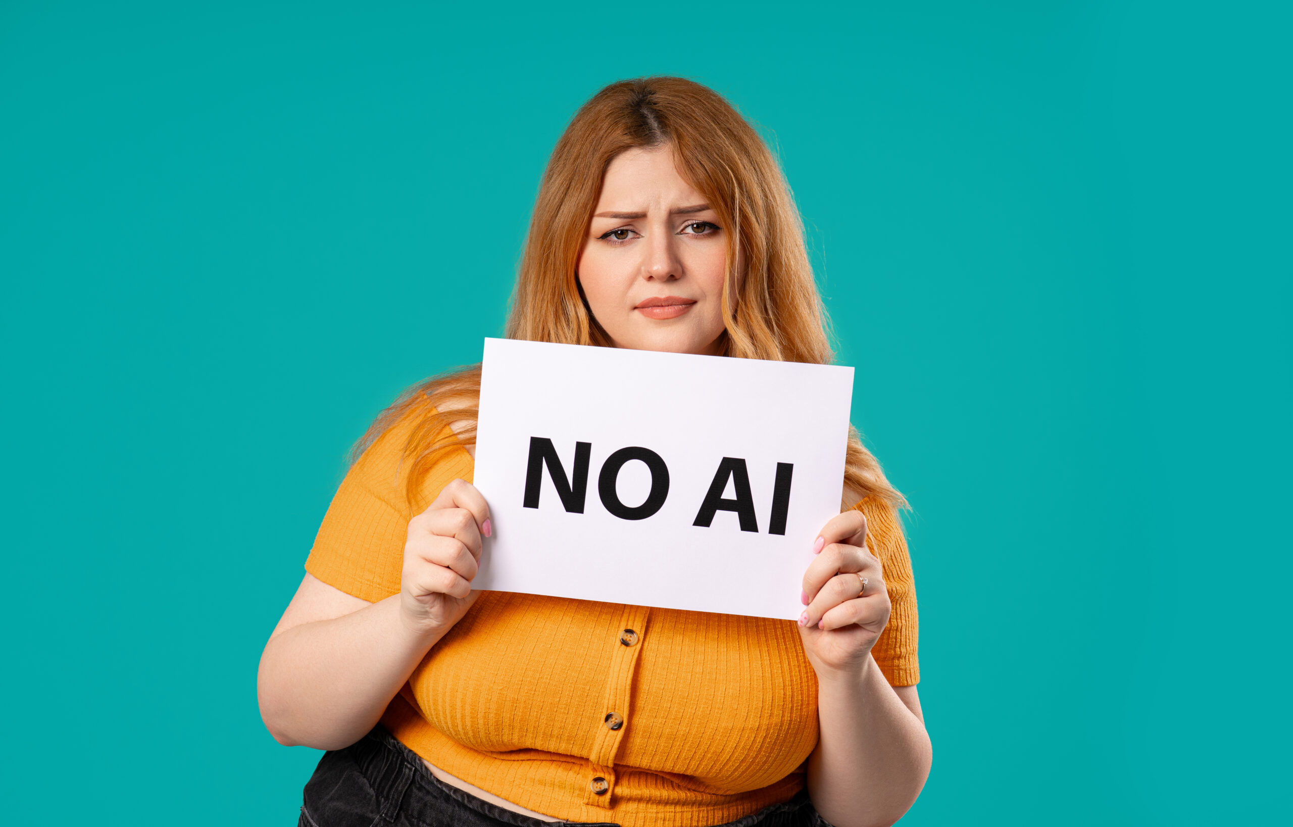 A customer acquisition strategist holding a No AI sign